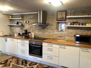 a kitchen with white cabinets and a wooden counter top at Kauba 6a apartment in Kuressaare