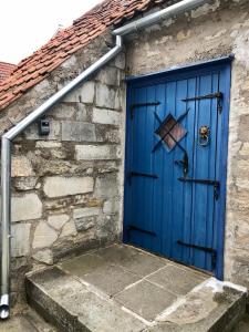a blue door on the side of a stone building at Kauba 6a apartment in Kuressaare