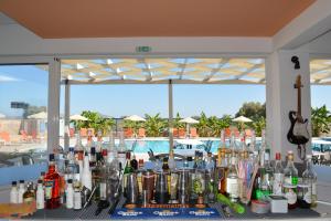 a table with a bunch of bottles and a guitar at Bouradanis Art Hotel in Marmari