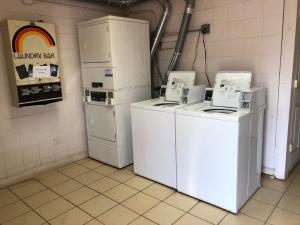 a laundry room with two washes and two refrigerators at Fairbridge Inn Express - Barrington in Barrington
