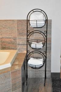 a black towel rack with white towels on a counter at Country Inn & Suites by Radisson, Hagerstown, MD in Hagerstown