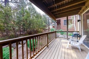 a porch with a white chair and a grill at Comfortable and Convenient Truckee Condo in Truckee