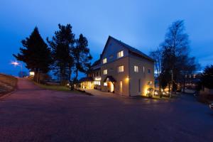 a large house with lights on the side of it at Hotel - Restaurant Sonneneck in Dornstetten