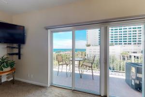 a room with a balcony with a view of the ocean at Paradise Perch in Fort Lauderdale