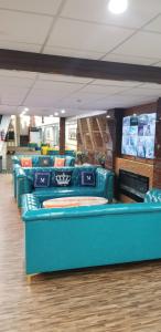 a row of blue couches in a waiting room at Baymont by Wyndham Montreal Airport in Dorval