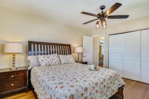 a bedroom with a bed and a ceiling fan at Turtle Beach Retreat in Layton
