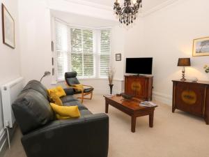 a living room with a couch and a coffee table at 2B Cavendish Villas in Buxton