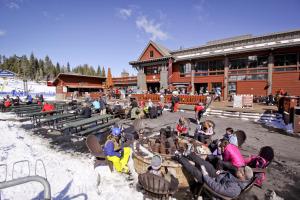 a group of people sitting in chairs in front of a building at Cozy Condo in Ski Trails in Truckee
