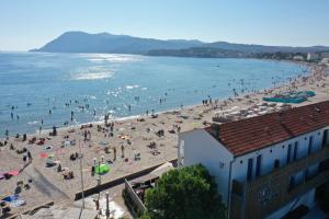 a group of people on a beach in the water at Hôtel George Sand in La Seyne-sur-Mer