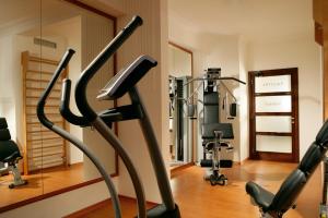 a gym with treadmills and exercise bikes in a room at Bettoja Hotel Atlantico in Rome