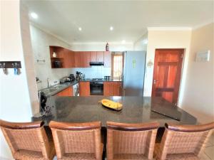 a kitchen with a table with a banana on it at Kuta Beach Unit 12 in Margate