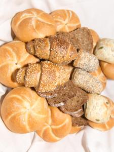 a pile of breads and buns on a table at Garni Dorfblick in Ischgl