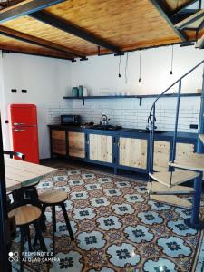 a kitchen with blue cabinets and a table and chairs at Appartamento Porto Marina S G 2 in Licata