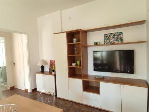 a living room with a flat screen tv on a wall at Verdolina - By Ligooria in Pietra Ligure