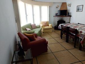 a living room with a couch and a table at VILLA VIDA - No se aceptan grupos de jóvenes in Mar del Plata