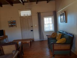 a living room with a couch and a table at Blye Uitsig in Oudtshoorn