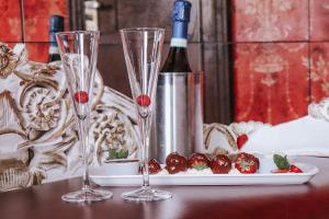 a table with two wine glasses and a plate of food at Le Monde Hotel in Edinburgh