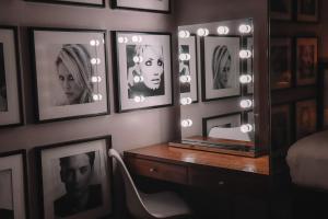 a room with pictures on the wall and a table with a mirror at Le Monde Hotel in Edinburgh