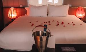 a bedroom with a bed with red roses on it at Le Monde Hotel in Edinburgh