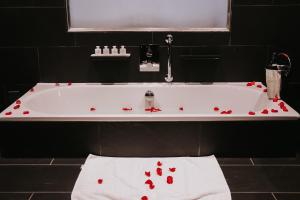 a white bath tub with red hearts on it at Le Monde Hotel in Edinburgh