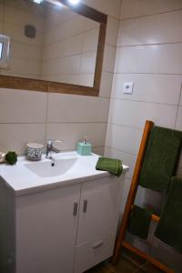 a bathroom with a sink and a mirror at Casa da Nonô in Coimbra