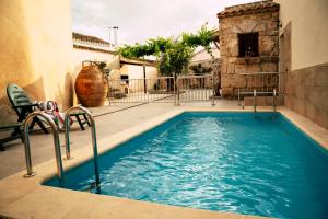 a swimming pool in the middle of a building at Casa Rural La Salitrosa in El Pedernoso