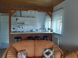 a living room with a couch and a kitchen at Vera in Hitzacker
