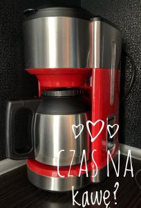 a red coffee maker with the words ka na kaya have at Apartament Brown Sugar Karwia in Karwia