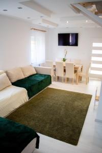 a living room with a couch and a dining room at Günter Vendégház-Hajdúnánás in Hajdúnánás