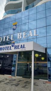 a hotel real sign on the side of a building at Hotel Real in Cabo Frio