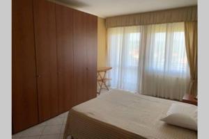 a bedroom with a large bed and a window at CASA VACANZA in Chiaravalle Centrale