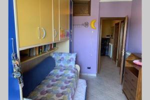a small living room with a couch and a cabinet at CASA VACANZA in Chiaravalle Centrale
