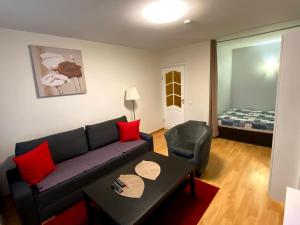 a living room with a couch and a table and a bed at Your Home - Central studio apartment, balcony, parking & Self Check-in in Vilnius +20 photos