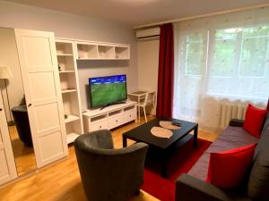 a living room with a couch and a tv at Vilnius central studio apartment in Vilnius