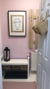 a hallway with a bench and a picture of a cat on the wall at SC design Home Apartman in Pécs