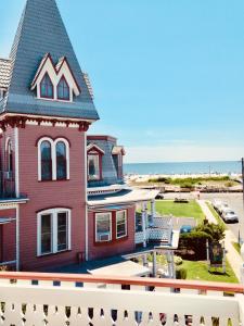 a house on the beach with the ocean in the background at Angel of the Sea Bed and Breakfast in Cape May