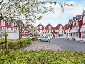 a car parked in front of a row of red and white buildings at Holiday home Gråsten LXVIII in Gråsten