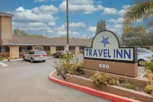 a travel inn sign in front of a parking lot at Travel Inn Sunnyvale in Sunnyvale