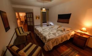 a bedroom with a bed and a chair in it at Wasi in Sucre