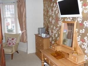 A television and/or entertainment center at All Seasons B&B 