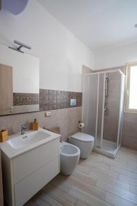 a bathroom with a sink and a toilet and a shower at CASA STELLA in Comiso