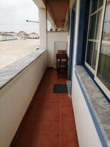 a balcony of a house with a table at Ocean Studio in Peniche