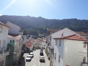 an aerial view of a town with cars parked on a street at A Mansão do Mé-Mé in Manteigas