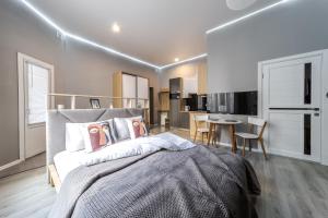 a bedroom with a large bed and a dining area at InshiApartments on Popovycha str 3 in Lviv