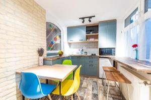 a kitchen with a wooden table and chairs at Central Garden Apartments in Sibiu
