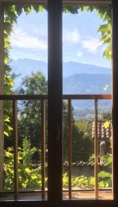a window looking out at a view of the ocean at Le Clos des May in Meylan