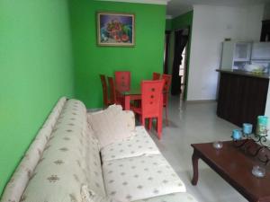 a living room with a couch and a table at Herard share apartamento in Punta Cana
