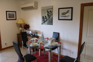 a dining room with a glass table and chairs at Waiotahi Valley Lodge in Thames