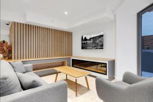a living room with two couches and a fireplace at S&P Apartments - Tank St in Brisbane