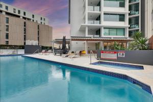 a large swimming pool in front of a building at S&P Apartments - Tank St in Brisbane
